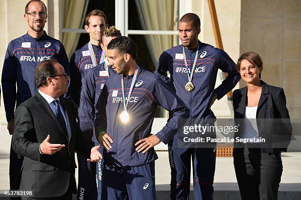 French President Francois Hollande speaks with men's 1500m gold medalist Mahiedine Mekhissi-Benabbad as French Minister for Women's Rights, Cities,...