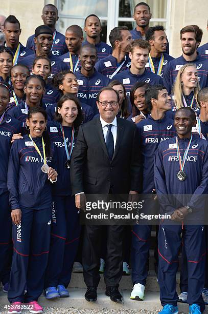 French President Francois Hollande poses with Athletes of the French athletics team at Elysee Palace on August 18, 2014 in Paris, France.