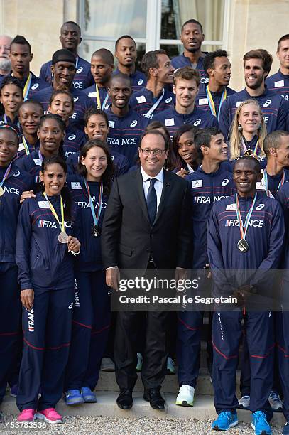 French President Francois Hollande poses with Athletes of the French athletics team at Elysee Palace on August 18, 2014 in Paris, France.