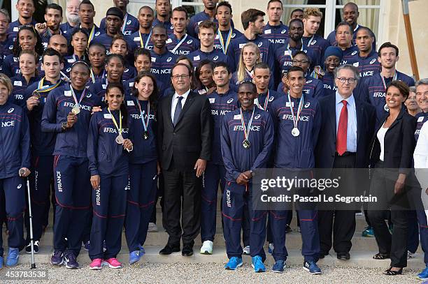 French President Francois Hollande poses with Athletes of the French athletics team, President of the French Athletics federation, Bernard Amsalem...