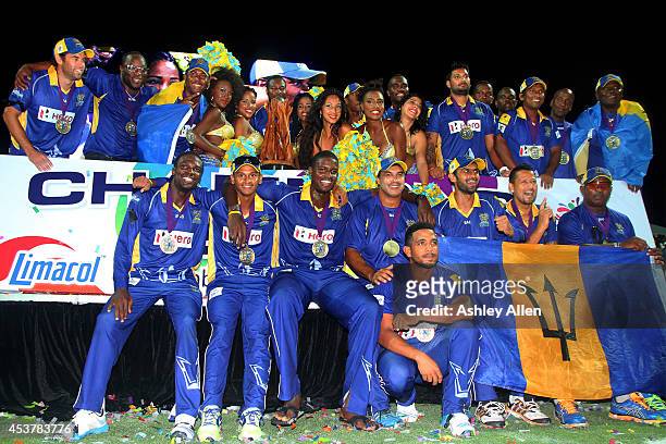Players of the Barbados Tridents pose with the trophy after winning the Limacol Caribbean Premier League 2014 final match between Guyana Amazon...