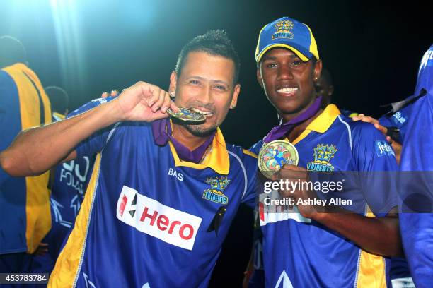 Rayad Emrit and Akeal Hosien of Barbado Tridents pose with their medals after the Limacol Caribbean Premier League 2014 final match between Guyana...