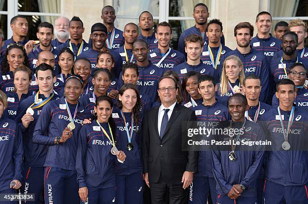 French President Francois Hollande poses with Athletes of the French athletics team at Elysee Palace on August 18, 2014 in Paris, France.