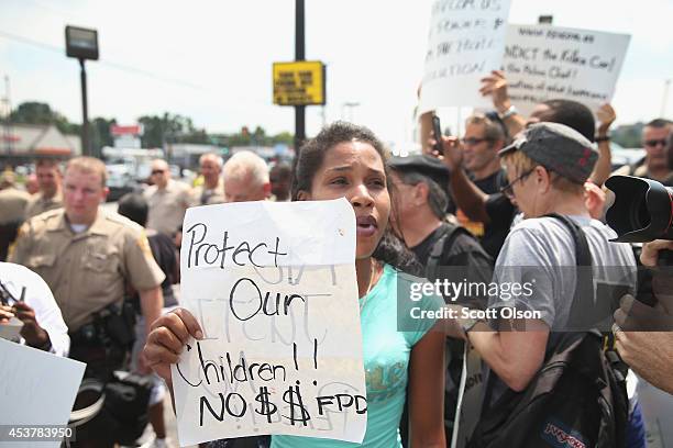 Demonstrators continue to protest the killing of teenager Michael Brown on August 18, 2014 in Ferguson, Missouri. After a protest yesterday ended...