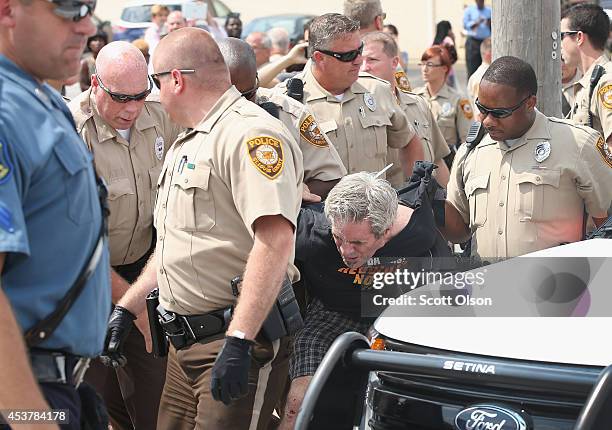 Police arrest a demonstrator protesting the killing of teenager Michael Brown on August 18, 2014 in Ferguson, Missouri. After a protest yesterday...