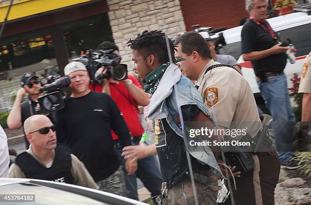 Police arrest a demonstrator protesting the killing of teenager Michael Brown on August 18, 2014 in Ferguson, Missouri. After a protest yesterday...