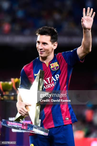 Lionel Messi of FC Barcelona holds the MVP trophy at the end of the Joan Gamper Trophy match between FC Barcelona and Club Leon at Camp Nou on August...