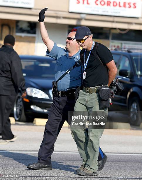 Getty Images staff photographer Scott Olson is escorted to a paddy wagon after being arrested by police as he covers the demonstration following the...
