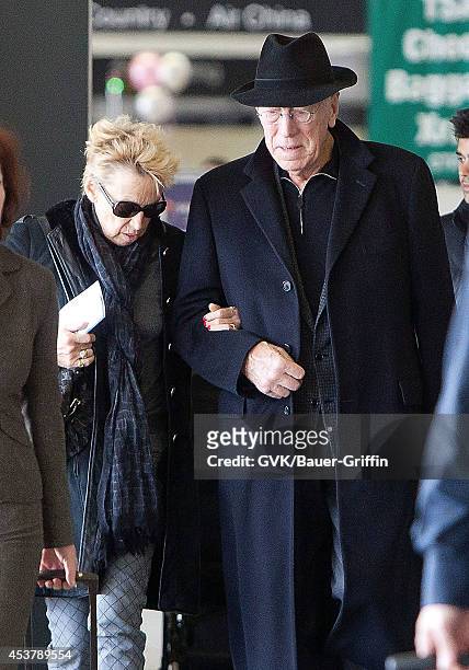Max Von Sydow and his wife Catherine Brelet is seen at Los Angeles International Airport on February 29, 2012 in Los Angeles, California.