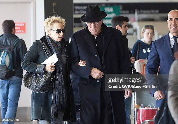 Max Von Sydow and his wife Catherine Brelet is seen at Los Angeles International Airport on February 29, 2012 in Los Angeles, California.