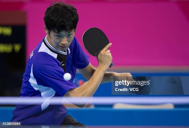 Yuto Muramatsu of Japan competes with Kim Minhyeok of South Korea in the Men's Singles Table Tennis quarter-final match on day three of the Nanjing...