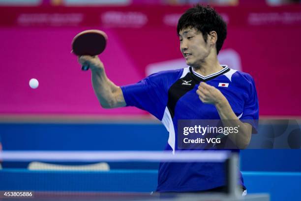 Yuto Muramatsu of Japan competes with Kim Minhyeok of South Korea in the Men's Singles Table Tennis quarter-final match on day three of the Nanjing...