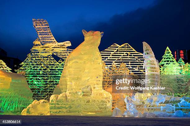 Japan, Hokkaido Island, Sapporo, Sapporo Snow Festival, Ice Sculptures Illuminated At Night.