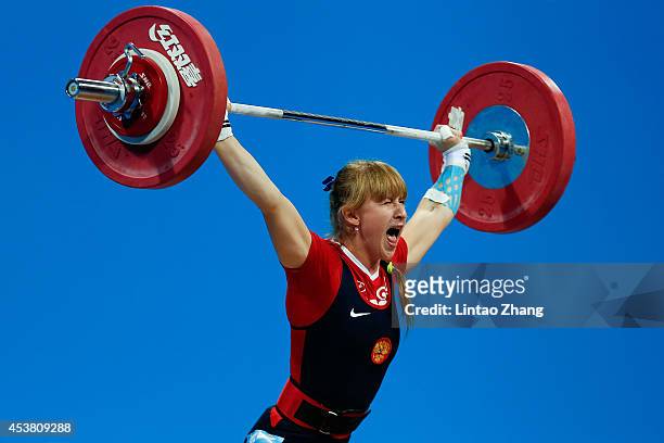 Anastasiia Petrova of Russia competes in the Women's 58kg Weightlifting on day three of the Nanjing 2014 Summer Youth Olympic Games at Nanjing...