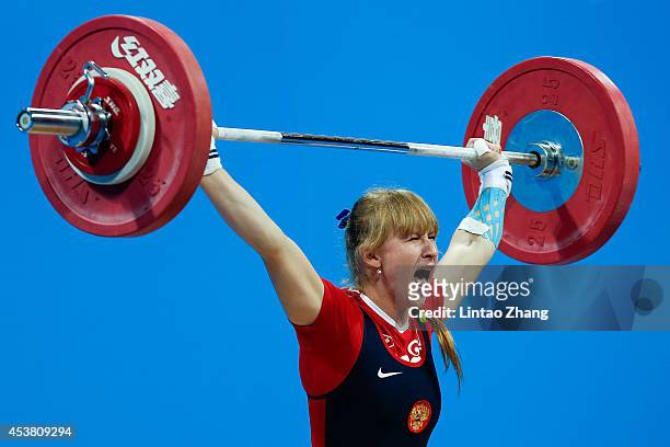 Anastasiia Petrova of Russia competes in the Women's 58kg Weightlifting on day three of the Nanjing 2014 Summer Youth Olympic Games at Nanjing...