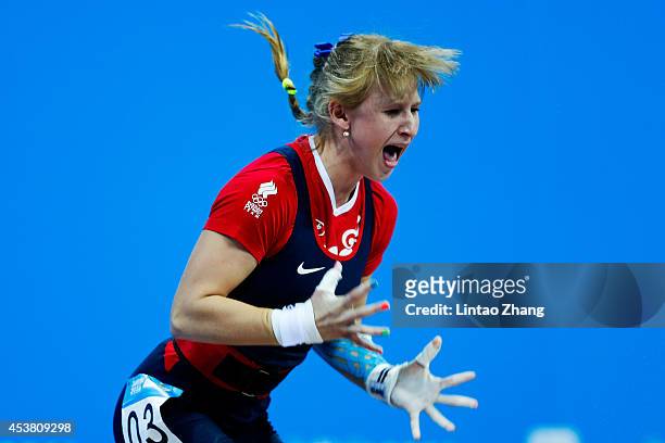 Anastasiia Petrova of Russia reacts in the Women's 58kg Weightlifting on day three of the Nanjing 2014 Summer Youth Olympic Games at Nanjing...