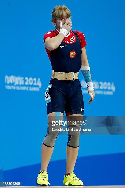 Anastasiia Petrova of Russia reacts in the Women's 58kg Weightlifting on day three of the Nanjing 2014 Summer Youth Olympic Games at Nanjing...