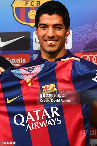 Luis Suarez of FC Barcelona poses for the media during a press conference as part of his presentation as new FC Barcelona player at Camp Nou on...