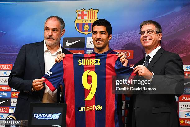 Barcelona Sport Director Andoni Zubizarreta, Luis Suarez and FC Barcelona Jordi Mestre of FC Barcelona pose for the media during a press conference...