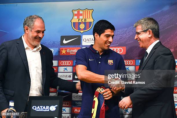 Barcelona Sport Director Andoni Zubizarreta, Luis Suarez and FC Barcelona Jordi Mestre of FC Barcelona pose for the media during a press conference...