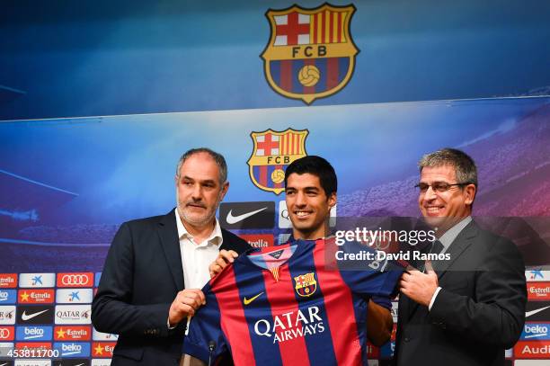 Barcelona Sport Director Andoni Zubizarreta, Luis Suarez and FC Barcelona Jordi Mestre of FC Barcelona pose for the media during a press conference...