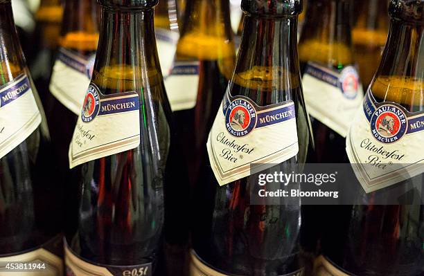 The Paulaner logo sits on Oktoberfest Bier labels as filled bottles move along the production line at the Paulaner Brauerei GmbH brewery in Munich,...