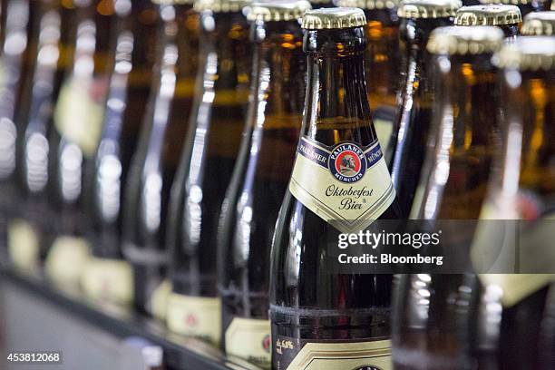 The Paulaner logo sits on Oktoberfest Bier labels as filled bottles move along the production line at the Paulaner Brauerei GmbH brewery in Munich,...