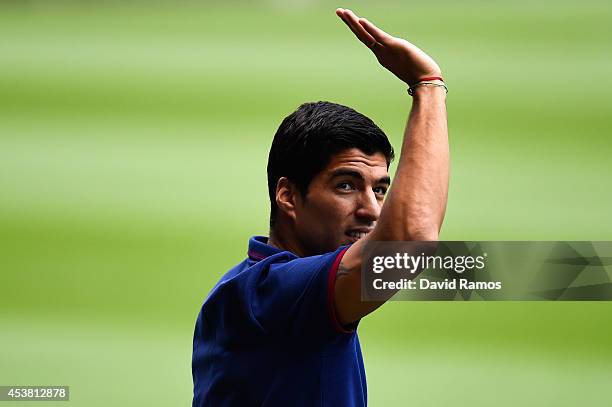 Luis Suarez of FC Barcelona waves during his presentation as new FC Barcelona player at Camp Nou on August 19, 2014 in Barcelona, Spain.