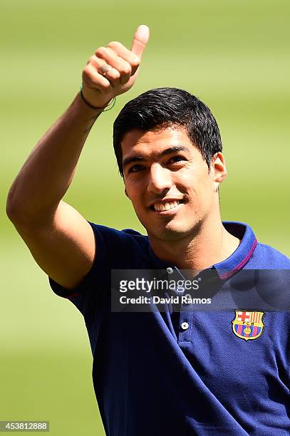Luis Suarez of FC Barcelona gives his thumbs up during his presentation as new FC Barcelona player at Camp Nou on August 19, 2014 in Barcelona, Spain.