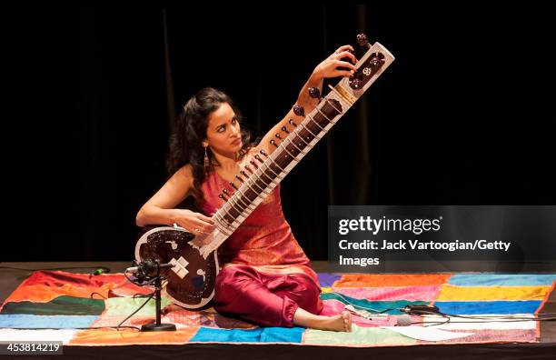 British-born Indian musician Anoushka Shankar tunes her sitar during a perfromance with her ensemble at a World Music Institute concert at New York...