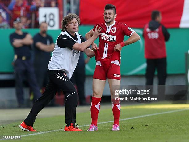 Head coach Stefan Kraemer of Cottbus and Fanol Perdedaj look on during the DFB Cup match between FC Energie Cottbus and Hamburger SV at Stadion der...