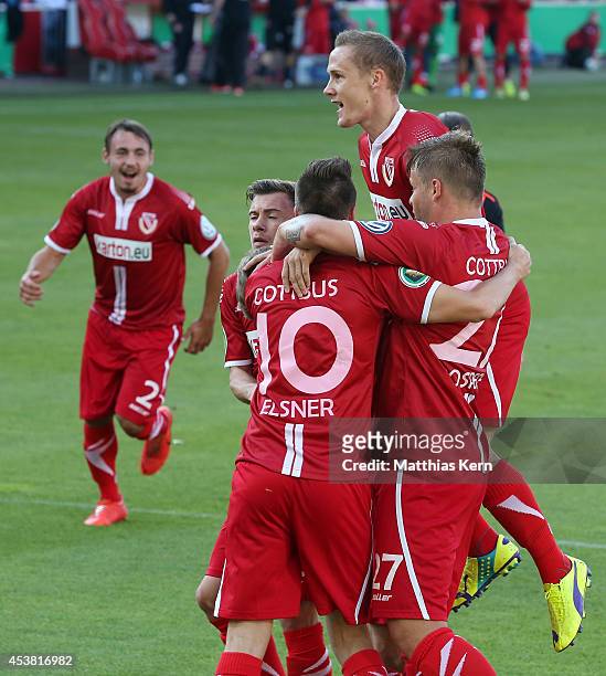 Manuel Zeitz of Cottbus jubilates with team mates after scoring the first goal after penalty during the DFB Cup match between FC Energie Cottbus and...