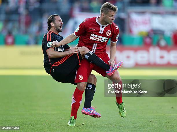 Petr Jiracek of Hamburg is attackt by Zbynek Pospech of Cottbus during the DFB Cup match between FC Energie Cottbus and Hamburger SV at Stadion der...