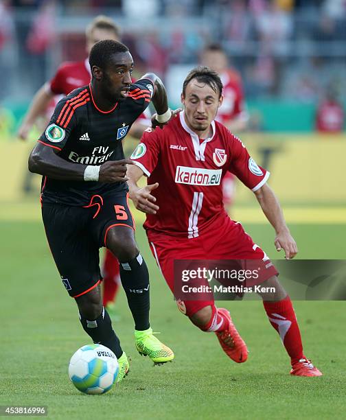 Johan Djourou of Hamburg battles for the ball with Robert Berger of Cottbus during the DFB Cup match between FC Energie Cottbus and Hamburger SV at...