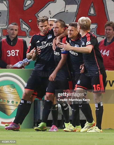 Rafael van der Vaart of Hamburg jubilates with team mates after scoring the third goal during the DFB Cup match between FC Energie Cottbus and...