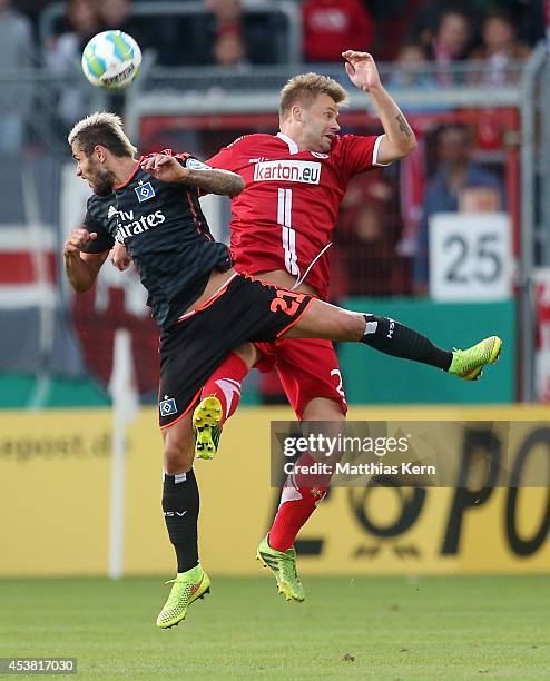 Petr Jiracek of Hamburg and Zbynek Pospech of Cottbus jump for a header during the DFB Cup match between FC Energie Cottbus and Hamburger SV at...