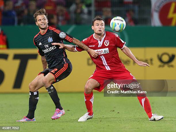 Dennis Diekmeier of Hamburg battles for the ball with Fabian Pawela of Cottbus during the DFB Cup match between FC Energie Cottbus and Hamburger SV...