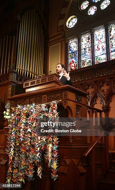 Reverend John Edgerton speaks from the pulpit during services at the Old South Church. A thousand origami cranes hang on the pulpit. Cranes sent to...