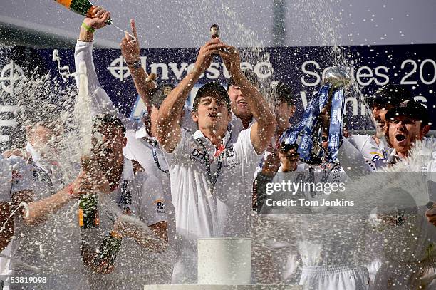 Alistair Cook lifts the ashes urn during the 5th Ashes Test Match day five between England and Australia at The Oval on August 25th 2013 in London .