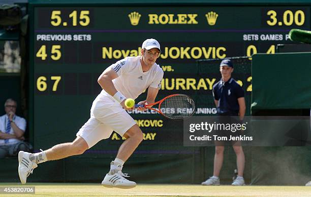 Andy Murray chases after the ball in the final game before winning the mens singles final on Centre Court during Wimbledon 2013 day thirteen at the...