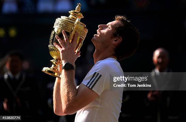 Andy Murray with the trophy at the presentation after the mens singles final on Centre Court during Wimbledon 2013 day thirteen at the All England...