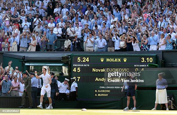 Andy Murray celebrates winning on matchpoint the mens singles final on Centre Court during Wimbledon 2013 day thirteen at the All England Lawn Tennis...