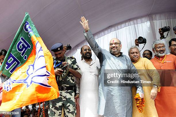 BJPs national president Amit Shah waves his hand on his maiden visit to state party office on August 19, 2014 in Lucknow, India. Shah said time has...