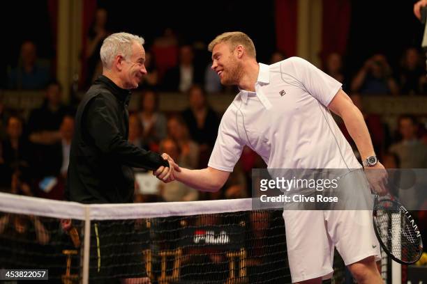 John McEnroe greets Andrew Flintoff after a challenge match whilst filming for 'A league of their own' on day two of the Statoil Masters Tennis at...