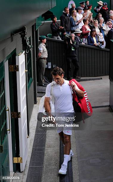 Dejected Roger Federer heads through the door exiting Centre Court after his defeat to Sergiy Stakhovsky on Centre Court during Wimbledon 2013 day...