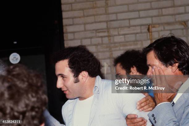 Police officers escort American accused serial killer David Berkowitz , known as the Son of Sam, into the 84th precinct station, New York, New York,...