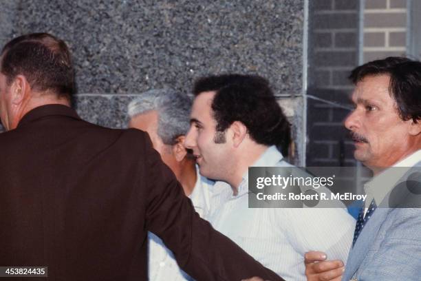 Police officers escort American accused serial killer David Berkowitz , known as the Son of Sam, into the 84th precinct station, New York, New York,...