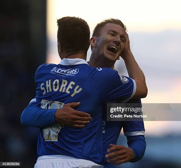 Jed Wallace of Portsmouth celebrates with Nicky Shorey after scoring his sides first goal during the Sky Bet League Two match between Portsmouth and...