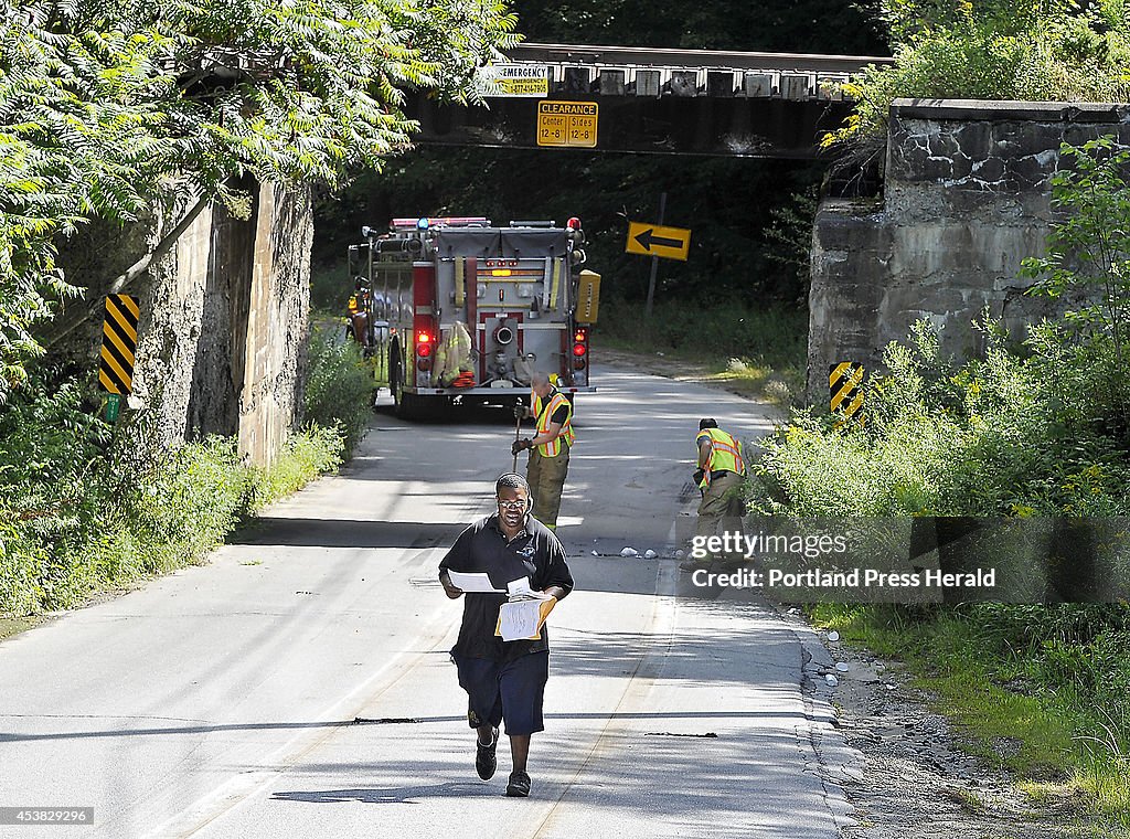 A tractor trailer truck gets caught beneath a RR bridge