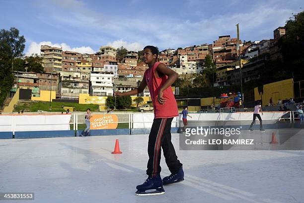 Boy skates in an artificial ice rink set by the Town Hall as part of Christmas celebration, in Petare shantytown, in Caracas, on December 5, 2013....